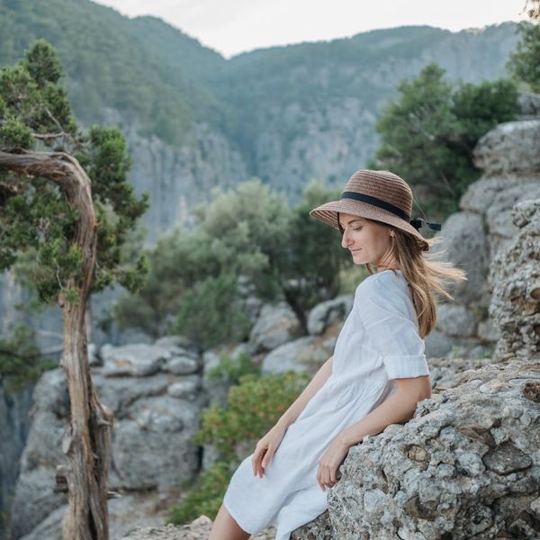 Person meditating peacefully in a natural environment with soft light.