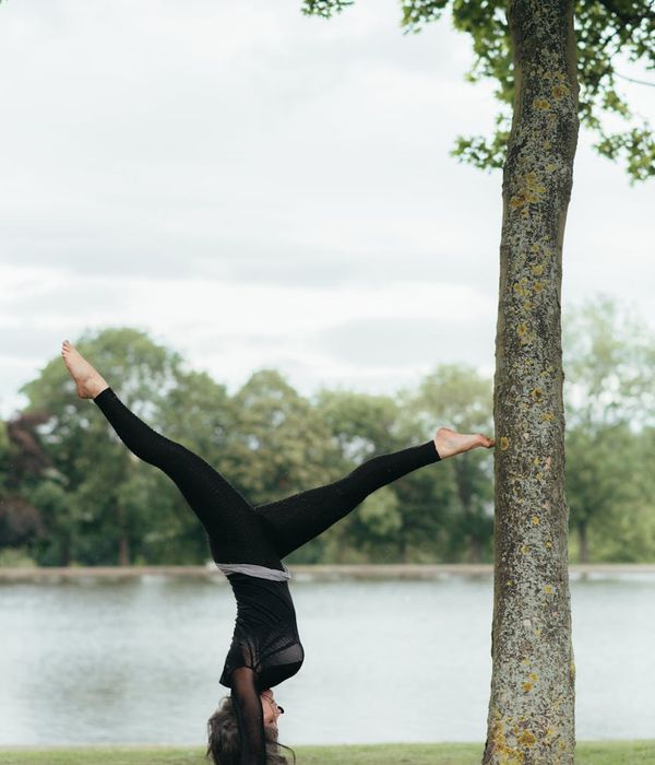 Woman performing a fluid yoga pose in a calm setting.